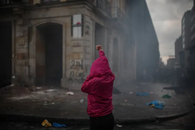 Thousands of protesters are seen streamed into the central Bolivar Square in clashes with the Mobile Anti-Disturbances Squadron (ESMAD in Spanish) in Bogota, Colombia on November 21, 2019. President Ivan Duque's government had ramped up security measures ahead of the marches, in the fear that Colombia could join the violent protest wave sweeping other Latin American countries. (Photo by Juancho Torres/Anadolu Agency via Getty Images)