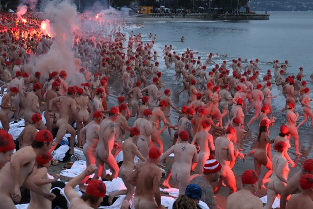 Swimmers participate in the annual nude winter solstice swim during Hobart's Dark Mofo festival at Long Beach in Hobart, Australia, 21 June 2024. (Photo by Ethan James/EPA/EFE)