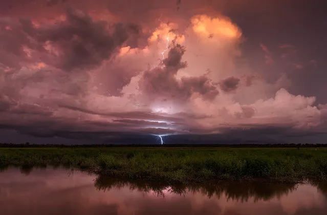 A distant storm emits a bolt at sundown. (Photo by Jacci Ingham/The Guardian)