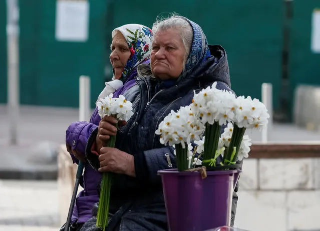 Elderly women wait for customers as they sell flowers in central Kiev, Ukraine April 27, 2017. (Photo by Gleb Garanich/Reuters)