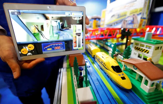 A tablet shows a live image from an onboard camera of Takara Tomy's Plarail Dr. Yellow at the International Tokyo Toy Show in Tokyo, Japan June 9, 2016. (Photo by Toru Hanai/Reuters)