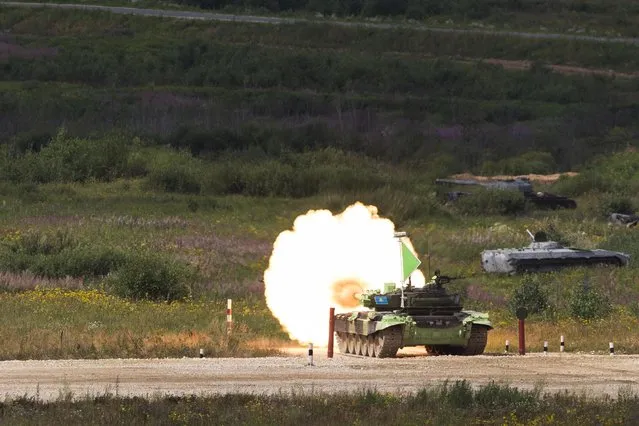 A Kazakhstan tank fires it's main armament during competition in Alabino, outside Moscow, Russia, Monday, August 3, 2015. (Photo by Pavel Golovkin/AP Photo)