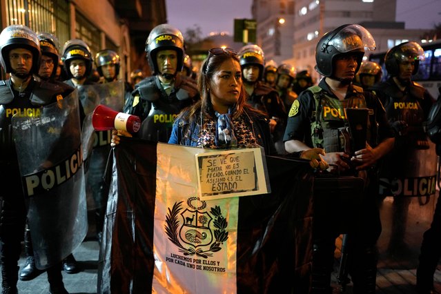 A demonstrator protest against government of Peru's President Dina Boluarte in front of congress building in Lima, Peru, Wednesday, June 14, 2023. Anti-government protesters seeking immediate elections, President Dina Boluarte's resignation, the release of ousted President Pedro Castillo and justice for protesters killed in clashes with police. (Photo by Martin Mejia/AP Photo)