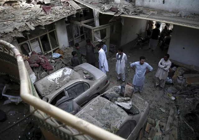 Men look at damages to their properties after a truck bomb blast in Kabul, Afghanistan August 7, 2015. “Last night's attack was a cowardly terrorist attack against civilians”, presidential spokesman Sayed Zafar Hashemi told reporters. (Photo by Ahmad Masood/Reuters)