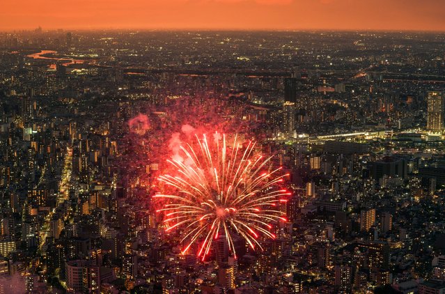 Fireworks explode over the Sumida River during the Sumida River Fireworks Festival at Asakusa, as seen from the Tokyo Skytree tower, in Tokyo, Japan, 27 July 2024. About 20,000 fireworks are fired during the festival’s 90-minute show, attracting over one million visitors. (Photo by Kimimasa Mayama/EPA/EFE)