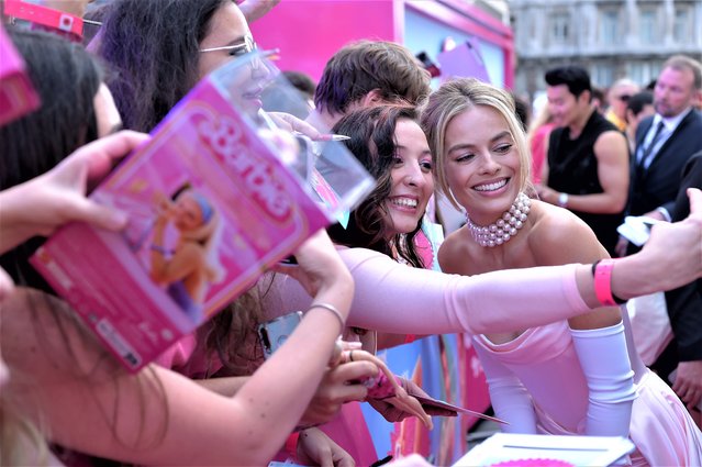 Australian actress Margot Robbie takes a selfie with fans during the European Premiere of “Barbie” at Cineworld Leicester Square on July 12, 2023 in London, England. (Photo by Antony Jones/Getty Images for Warner Bros.)