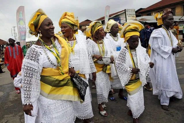 Devotees of the river goddess Osun dance down  a street during the traditional town cleansing procession at the start of the annual Osun festival in Osogbo in Nigeria's southwest, August 10, 2015. (Photo by Akintunde Akinleye/Reuters)