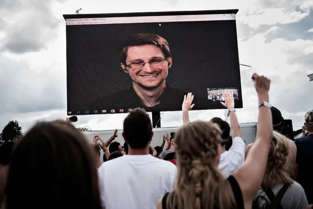 American whistleblower Edward Snowden is seen on a screen as he delivers a speech during the Roskilde Festival in Roskilde, Denmark, June 28 2016. (Photo by Mathias Loevgreen Bojesen/Reuters/Scanpix Denmark)