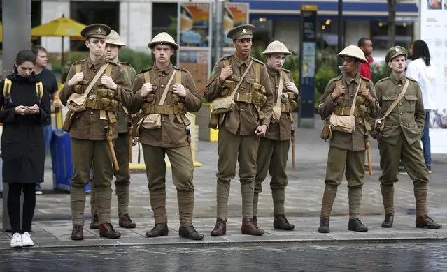 Actors dressed in World War 1 army fatigues walk silently in the streets near Waterloo Station, to commemorate the start of the Battle of The Somme, in London, Britain July 1, 2016. (Photo by Peter Nicholls/Reuters)