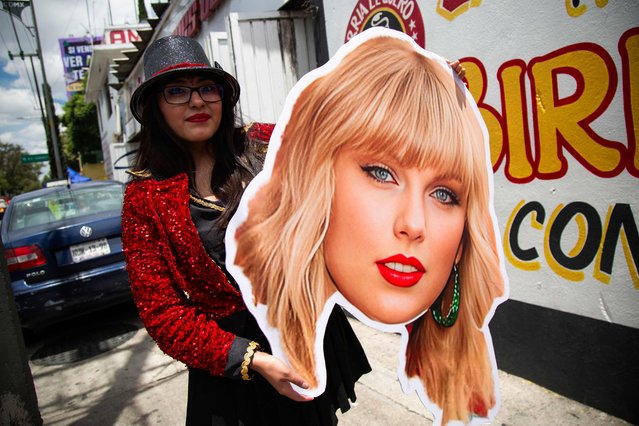 A fan of US superstar Taylor Swift holds a poster with the image of a singer before her presentation at the Foro Sol in Mexico City on August 24, 2023. (Photo by Rodrigo Oropeza/AFP Photo)