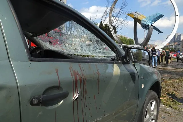Blood stains are seen on a damaged car after a deadly Russian missile attack in Vinnytsia, Ukraine, Thursday, July 14, 2022. (Photo by Efrem Lukatsky/AP Photo)