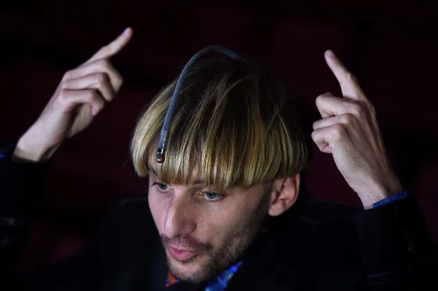 British Neil Harbisson, the world's first certified cyborg, speaks to the media in Brisbane, Australia, 20 August 2015. Mr Harbisson, who is completely color blind, has an antenna with a camera at its end permanently implanted in his head that allows him to perceive colors as different sounds. (Photo by Dan Peled/EPA)