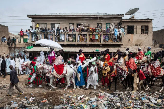 The Emir of Kano, Muhammadu Sanusi II, rides a horse as he parades with his entourage and musicians on the streets of Kano, northern Nigeria on July 6, 2016, during the Durbar Festival celebrating the Eid al-Fitr which marks the end of the Islamic holy fasting month of Ramadan. (Photo by Stefan Heunis/AFP Photo)