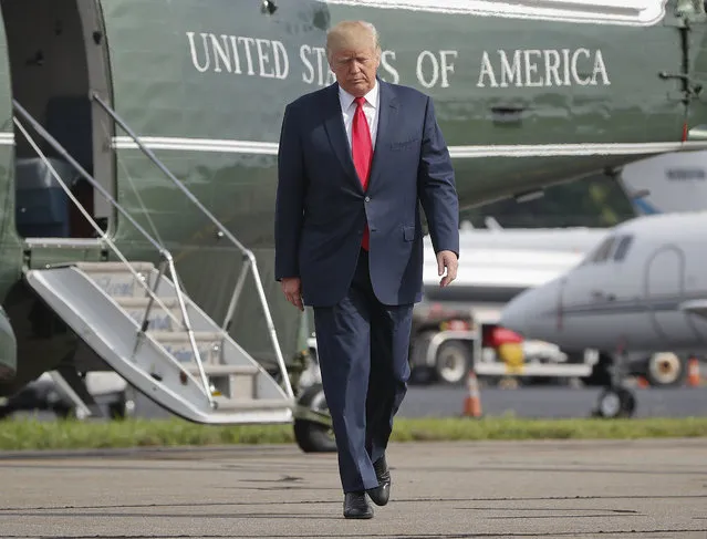 In this August 14, 2017 file photo, President Donald Trump walks across the tarmac from Marine One to board Air Force One at Morristown Municipal Airport in Morristown, N.J. Bombarded by the sharpest attacks yet from fellow Republicans, President Donald Trump on Thursday, Aug. 17, 2017, dug into his defense of racist groups by attacking members of own party and renouncing the rising movement to pull down monuments to Confederate icons. (Photo by Pablo Martinez Monsivais/AP Photo)