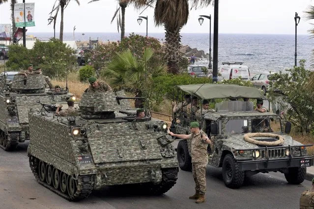 Lebanese army vehicles patrol a street in Beirut, Lebanon, Saturday, May 14, 2022. Lebanese authorities began distributing ballot boxes to polling stations around the country on Saturday, a day before parliamentary elections were to be held. (Photo by Bilal Hussein/AP Photo)