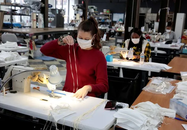 Analiese Zaleski sews hospital masks, as the spread of coronavirus disease (COVID-19) continues, on day one of turning the Detroit Sewn facility into a production facility for hospital masks in Pontiac, Michigan, U.S., March 23, 2020. (Photo by Rebecca Cook/Reuters)