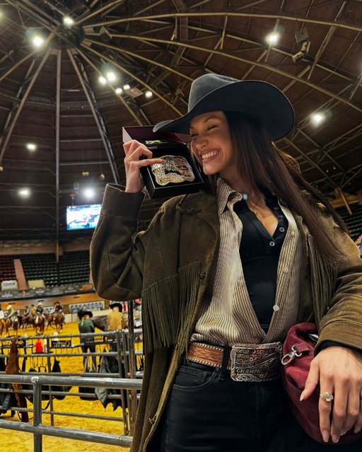 Dressed in a black cowboy hat and green tasselled jacket, American model Bella Hadid beams with pride as she holds up her medal on December 11, 2024. (Photo by belladhadid/Instagram)