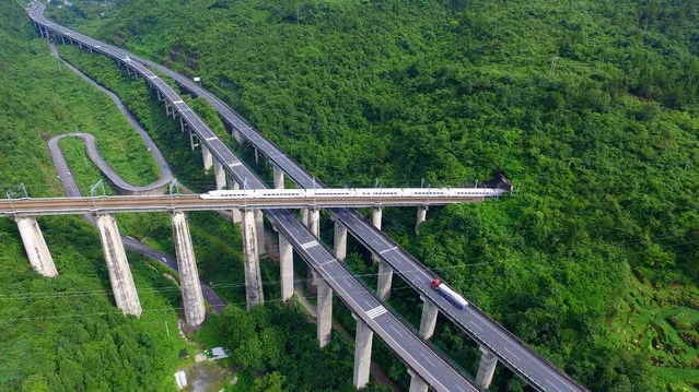 A high-speed train crosses a viaduct on the Yichang-Wanzhou railway in Enshi, China  on July 28, 2016. (Photo by Xinhua/Barcroft Images)