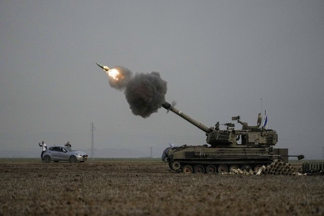 An Israeli mobile artillery unit fires a shell from southern Israel towards the Gaza Strip, in a position near the Israel-Gaza border on Thursday, December 14, 2023. (Photo by Leo Correa/AP Photo)