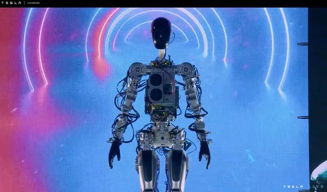 This video screen grab made from Tesla AI Day 2022 livestream shows the humanoid robot walking on stage in Palo Alto, California on September 30, 2022. (Photo by Various sources/AFP Photo)