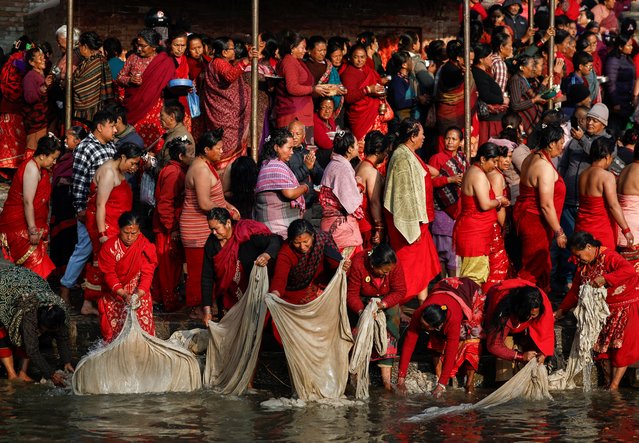 Women wash clothes used by devotees after taking a holy dip at the Hanumante River during the final day of the month-long Swasthani Brata Katha festival in Bhaktapur, Nepal on February 12, 2025. (Photo by Navesh Chitrakar/Reuters)