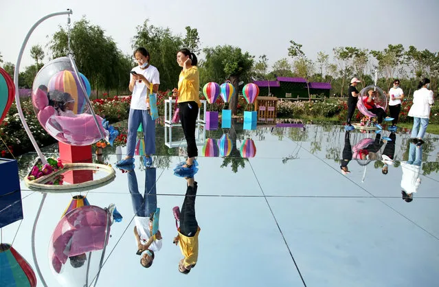 A 100 square meter “sky mirror” can be seen inside the Linxiang Four Season Estate, offering a storybook landscape during summertime, Xiangfen City, north China's Shanxi Province, 21 June 2020. (Photo by Rex Features/Shutterstock)