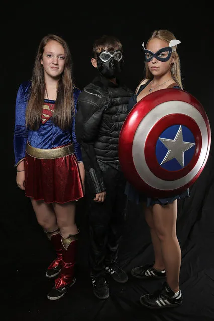 Comic Con attendees pose during the 2014 New York Comic Con at Jacob Javitz Center on October 9, 2014 in New York City. (Photo by Neilson Barnard/Getty Images)