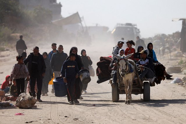 Palestinians make their way to flee their homes, after the Israeli army issued evacuation orders for a number of neighborhoods, following heavy Israeli strikes, in Beit Lahiya in the northern Gaza Strip on March 18, 2025. (Photo by Abd Elhkeem Khaled/Reuters)