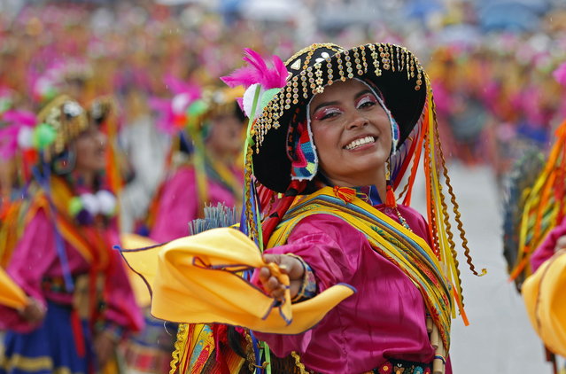 A choreographic collective dances in the street during a parade of the Blacks and Whites' Carnival in Pasto, southwestern Colombia, 03 January 2024. The city of Pasto kicked off the year with its traditional Blacks and Whites Carnival. The annual event is recognized as an Intangible Cultural Heritage of Humanity by UNESCO. This year's festivities take place between 02 and 08 January. (Photo by Mauricio Duenas Castaneda/EPA)