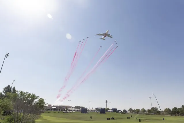 The Red Arrows and an Emirates A380 fly in formation over the DP World Tour Championship golf tournament at the Jumeirah Earth Golf Course in Dubai, United Arab Emirates on November 17, 2022. (Photo by Antonie Robertson/The National)