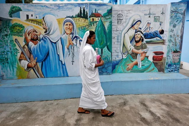 A nun belonging to the global Missionaries of Charity walks past a mural at Prem Dan, a home for the destitute and old run by the Missionaries of Charity, ahead of Mother Teresa's canonisation ceremony, in Kolkata, India September 1, 2016. (Photo by Rupak De Chowdhuri/Reuters)