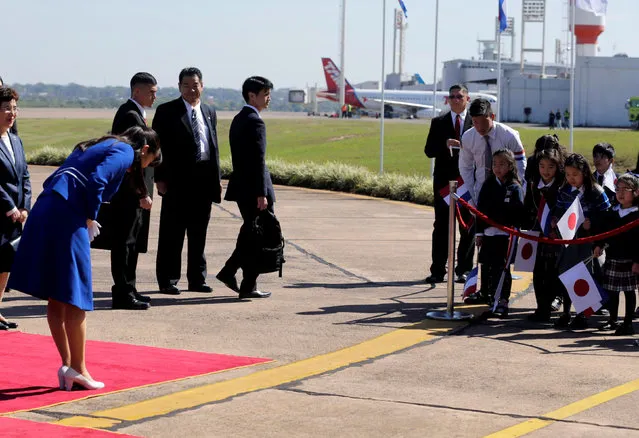 Japan's Princess Mako (front L) is greeted by students after her arrival at the Silvio Pettirossi International Airport in Luque, Paraguay September 7, 2016. (Photo by Jorge Adorno/Reuters)