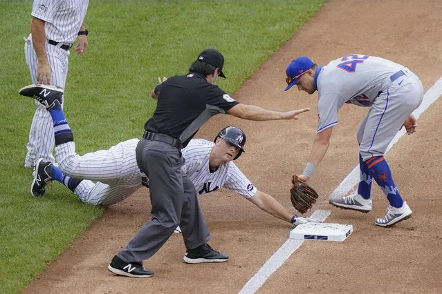 New York Yankees' DJ LeMahieu, center, beats the tag at third by New York Mets third baseman J.D. Davis, right, on a triple hit off starting pitcher Robert Gsellman in the third inning of a baseball game, Saturday, August 29, 2020, in New York. (Photo by John Minchillo/AP Photo)