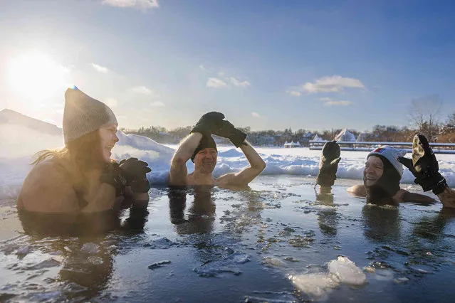 Rachel, left, Sandor, center, and Steve, members of the “Submergents” group take the plunge into –6 ° F air temp in a pool carved from the ice, Thursday, December 22, 2022 at Lake Harriet in Minneapolis. (Photo by Kerem Yücel/Minnesota Public Radio via AP Photo)