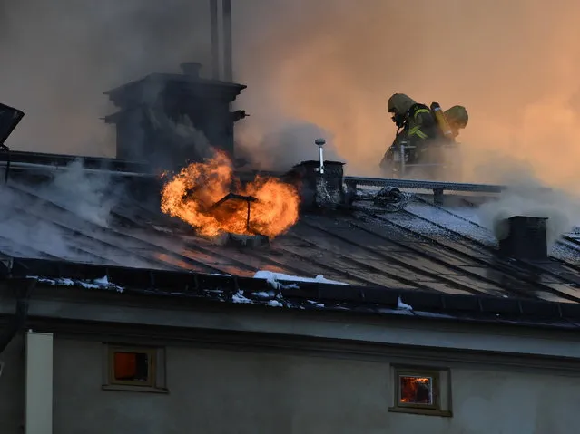 Firefighters try to extinguishing a fire at the Royal Institute of Art in Stockholm, Sweden, Wednesday, September 21, 2016. A fire has started in a building belonging to Stockholm's Royal Institute of Art, sending a plume of smoke over large parts of the Swedish capital. Dozens of firefighters struggled to contain the blaze, which raced through the attic and roof of the building on Skeppsholmen island near downtown Stockholm on Wednesday. There were no reports of injuries. (Photo by Anders Wiklund/TT News Agency via AP Photo)