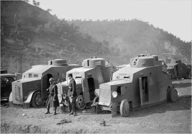 Picture dated February 1939 showing a French soldier and a French policeman standing guard next to armored vehicles of the Spanish Republican army seized and disarmed in the French Pyrenees after the Republicans lost the Spanish civil war against Franco. (Photo by STF/AFP Photo/Getty Images)