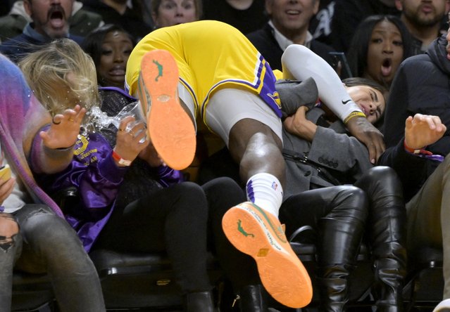Los Angeles Lakers forward LeBron James (6) lands on fans sitting court side as he dives after a ball in the second half against the Los Angeles Clippers at Crypto.com Arena in Los Angeles, California on January 24, 2023. (Photo by Jayne Kamin-Oncea/USA TODAY Sports)