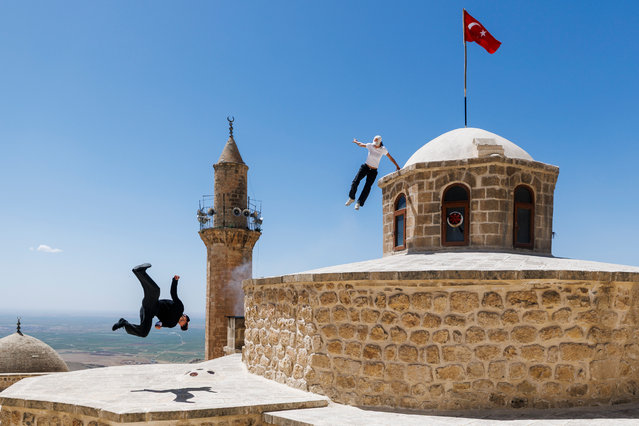 Freerunners Hazal Nehir and Lilou Ruel leap from centuries-old rooftops in Mardin in southeastern Turkey on July 14, 2025. (Photo by Cover Images)