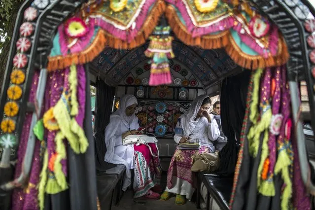 Students sit in public transport outside the Psychology Department of the University of Peshawar November 24, 2014. (Photo by Zohra Bensemra/Reuters)