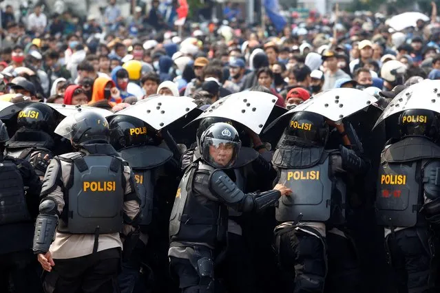 Riot police officers are seen during a protest against the government's labor reforms in “jobs creation” bill in Jakarta, Indonesia, October 8, 2020. (Photo by Ajeng Dinar Ulfiana/Reuters)