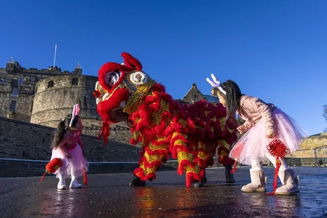Five-year-olds Annabelle Ye and Luna Chen join the dragon at Edinburgh Castle in the second decade of January 2023 to launch the city’s Chinese New Year celebrations. The Year of the Rabbit runs from January 20 to February 3. (Photo by Duncan McGlynn/The Times)