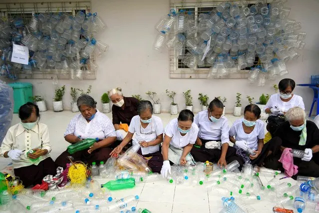 Women clean recycled plastic bottles at Thabarwa meditation center in Thanlyin, Yangon in Myanmar, September 4, 2020. (Photo by Shew Paw Mya Tin/Reuters)