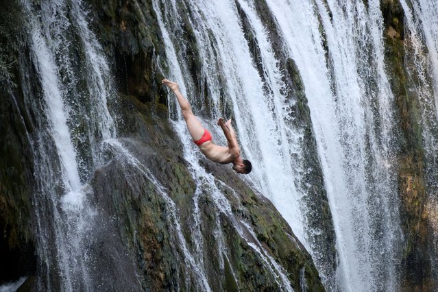 A competitor takes part in the annual international waterfall jumping competition held in the old town of Jajce, Bosnia and Herzegovina, on August 9, 2025. (Photo by Amel Emric/Reuters)