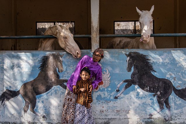 Members of Yogyakarta classic bicycle group pose with horses after taking part in a ceremonial event to mark the 80th Indonesian Independence Day on August 17, 2025 in Yogyakarta, Indonesia. Indonesia became an independent nation on August 17, 1945, having previously been under Dutch rule. (Photo by Ulet Ifansasti/Getty Images)