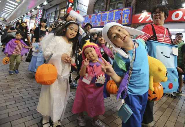 In this October 24, 2015 photo, participants parade during an annual Halloween event in Kawasaki, near Tokyo. Although Japan has its own traditional festivals to celebrate spookiness and honor the dead, Halloween is being observed with a special frenzy. (Photo by Koji Sasahara/AP Photo)