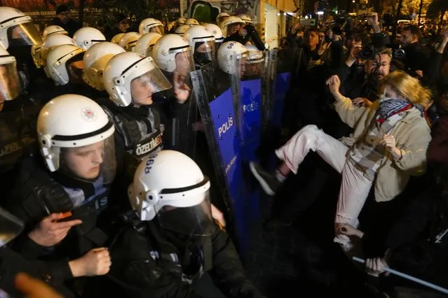 Protesters scuffle with anti riot policemen at the end of the gathering to mark the International Women's Day in Istanbul, Turkey, Wednesday, March 8, 2023. Women in Turkey and their allies converged on a central Istanbul neighborhood to demonstrate for women's rights and protest the human-made toll of the deadly quake that hit Turkey a month ago. (Photo by Khalil Hamra/AP Photo)