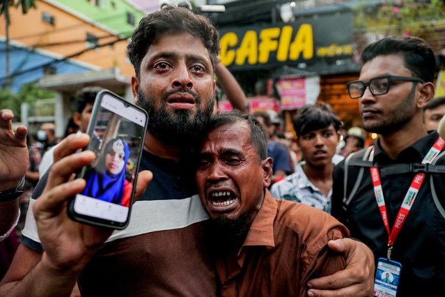A relative wails as he shows a picture of a fire accident victim, who works as a garment factory worker, outside the chemical and garments factory in Dhaka on October 14, 2025. At least 16 people were killed after a fire blazed through a chemical and garments factory in Bangladeshi capital of Dhaka on October 14, fire authorities said. (Photo by AFP Photo/Stringer)