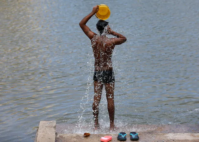 A boy bathes on the banks of Kelani river on a hot day in Colombo, Sri Lanka September 6, 2016. (Photo by Dinuka Liyanawatte/Reuters)