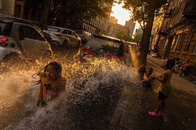 Miranda, 8, cools off and plays in water sprayed from a fire hydrant during hot weather on July 16, 2024 in the Washington Heights neighborhood of New York City. New York City is in the middle of the third heat wave of the season, with temperatures that could feel like up to or over 100 degrees. (Photo by Adam Gray/Getty Images)