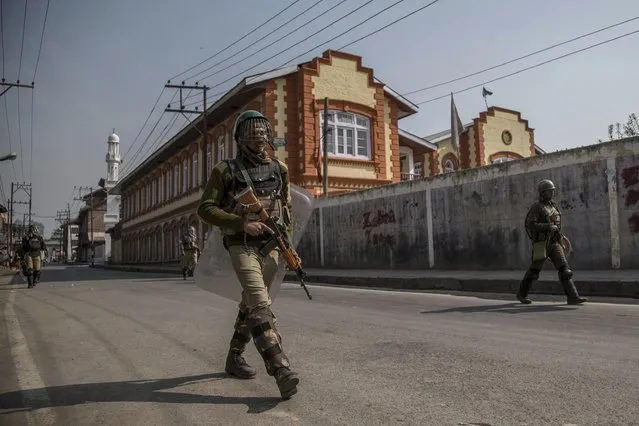 Indian paramilitary soldiers patrol during curfew in Srinagar, Indian controlled Kashmir, Friday, October 28, 2016. Authorities on Friday imposed curfew in some parts of Srinagar to foil a pro-freedom march to the Grand mosque called by separatist leaders. The march was called in protest after no one was allowed to pray inside the mosque on Fridays for nearly 16 weeks. (Photo by Dar Yasin/AP Photo)